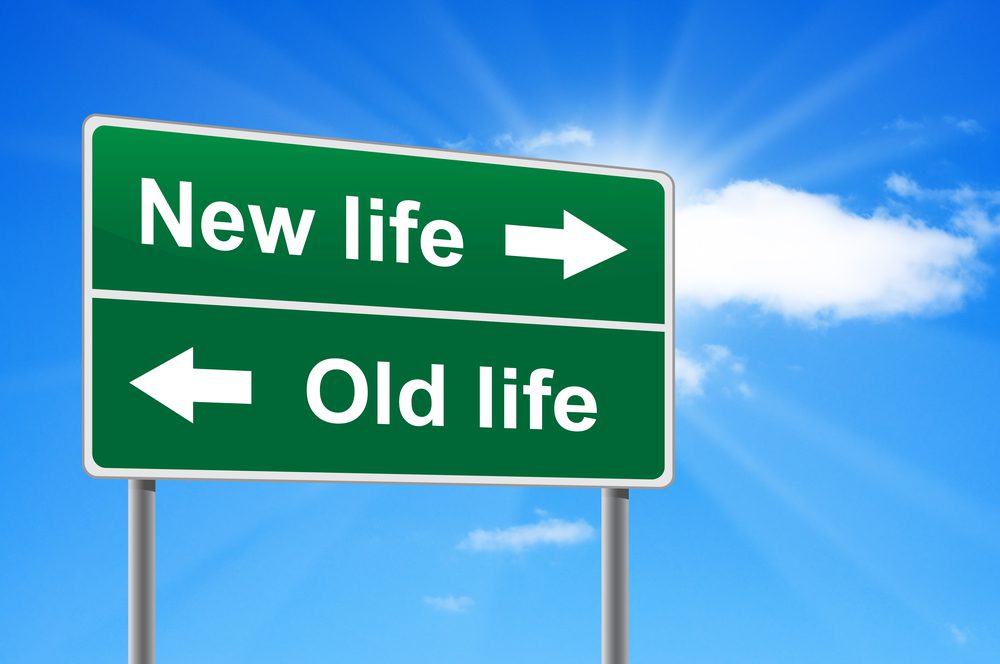 Sign signs new life one way and old life the other way, choose sustainable permaculture living