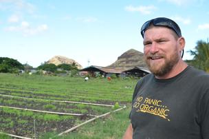 Mao Organic Farm worker posing by permaculture fields in Hawaii.